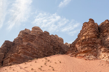 Fototapeta na wymiar Unforgettable high mountains in the endless sandy red desert of the Wadi Rum near Amman in Jordan