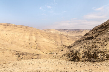 View of the low mountains in the gorge Wadi Al Ghuwayr or An Nakhil and the wadi Al Dathneh from the road leading to it near Amman in Jordan