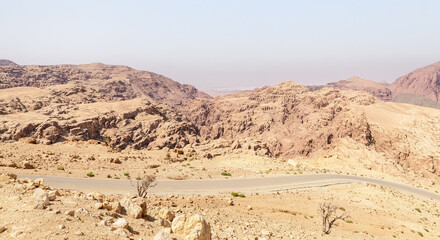 View of low mountains in gorge Wadi Al Ghuwayr or An Nakhil and the wadi Al Dathneh from the road leading to it near Amman in Jordan