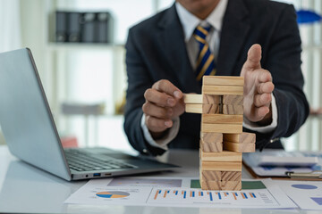 Business risk or finance concept, to prevent business risk and choose the right wooden block game...