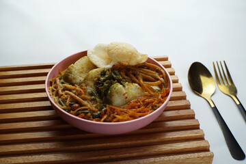 Lontong with curry soup accompanied by fried sweet potatoes chili sauce and noodles