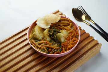 Lontong with curry soup accompanied by fried sweet potatoes chili sauce and noodles