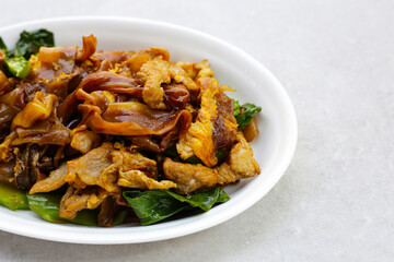 Stir-fried rice noodles with soy sauce and pork