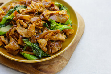 Stir-fried rice noodles with soy sauce and pork