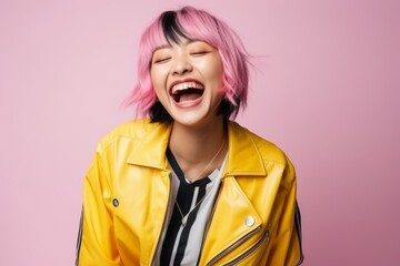 Beautiful young asian woman with pink hair wearing a yellow jacket