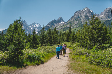 Fototapeta na wymiar People hiking toward the Teton mountain range in Grand Teton National Park