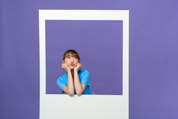 young lady dressed blue clothes smiling looking through white window
