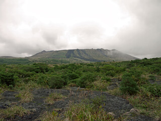 Distant Mount Mihara volcano summit view from volcanic landscape valley, Izu Oshima island, Japan