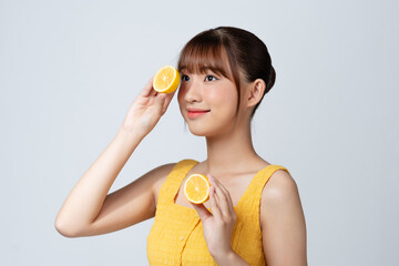 Cheerful feminine girl, natural clear skin, girl with two lemon slices, isolated on a white background