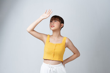 Beautiful Asian young woman hand up cover face protect sun light and UV smile with clean fresh skin