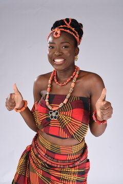 Young black African Nigerian igbo looking gorgeous wearing native attire holding up thumbs closer up smiling