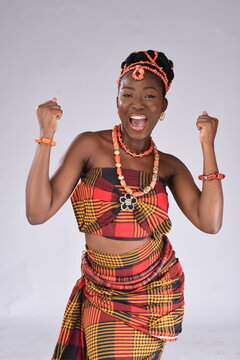 Young black African Nigerian lady happily holding fits up igbo looking gorgeous wearing native attire