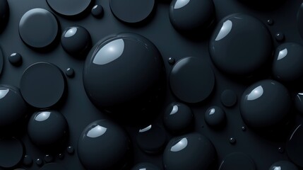 Varied sizes of shiny dark spheres arranged on a matte black background creating a contrast of textures.
