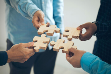 Concept of teamwork and partnership. Business hands join puzzle pieces in the office. business...