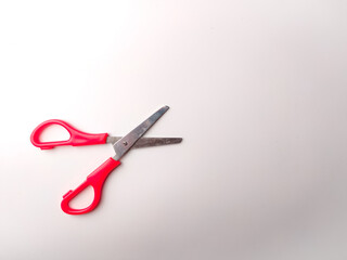 Top view red scissors on a white background