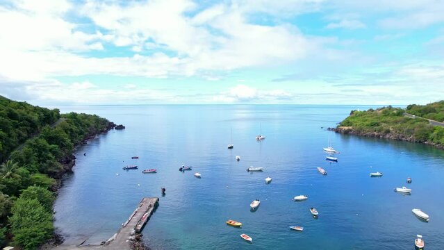 Many boats moored near tropical coastline of Guadeloupe, aerial view