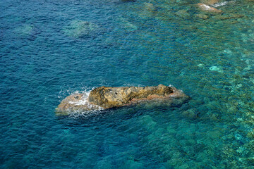 Rocky sea floor visible through crystal clear turqoise water of Mediterranean sea in Cinque Terre，Italy