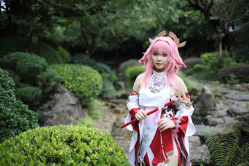 Portrait of a beautiful young woman game cosplay on japanese garden