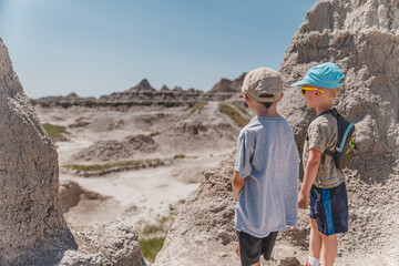 Two brothers looking out at the rock formations of Badlands National Park