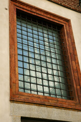 Window with a medieval-style grille.Glass Tiled Window