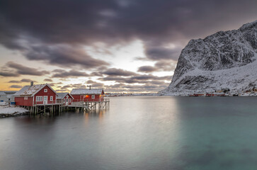 norway lofoten islands winter season snow covered landscapes beaches cloudy sky and colorful houses