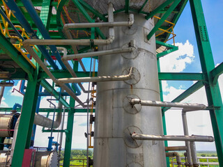 distillation column tower with some pipe connected to every tray in it