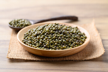 Green mung bean in wooden bowl with spoon, Food ingredients