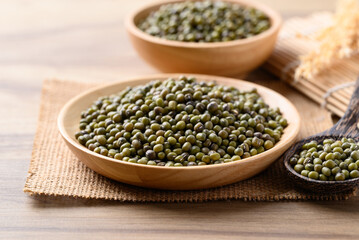 Green mung bean in wooden bowl with spoon, Food ingredients
