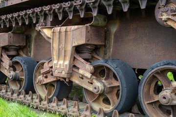Detail of the wheels and track of a rusty Sherman WWII tank
