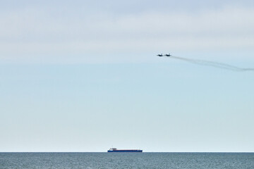Two Russian military fighter planes armed with missiles fighter jets flying over sea, airborne...