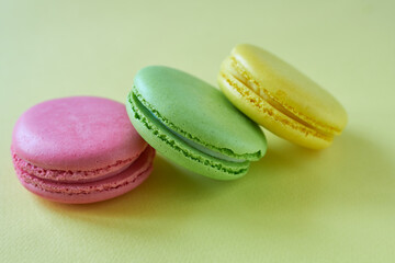 Colorful macaroons on a yellow background. Pastel colors.