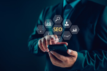 Businessman using smartphone for analysis SEO Search Engine Optimization Marketing Ranking Traffic...