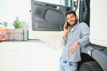 Portrait of confident indian truck driver on parking. Copy space.