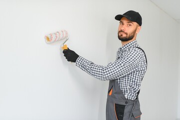 Young worker making repair in room.