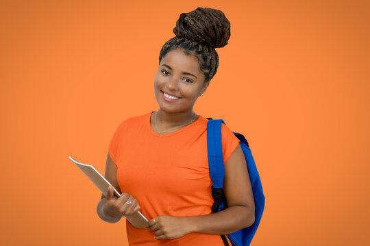Beautiful laughing african american female student with backpack and paperwork