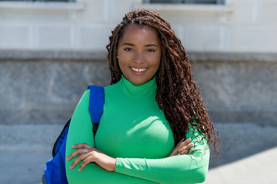 Beautiful black female student with dreadlocks and green shirt
