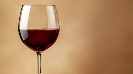Glass of red wine on a beige background.