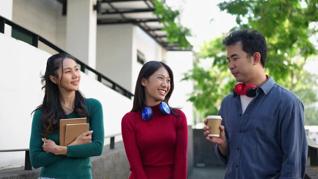 Group of confident Asian students wearing headphones, relaxing, studying information, talking, sharing ideas, communicating, seeking knowledge, online, and managing on laptops at university.