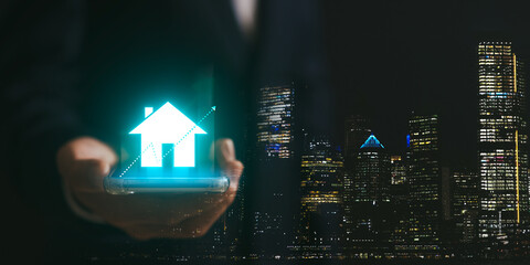 Real estate investment ideas, Businessman hand holding house icon. Real estate online on a virtual...