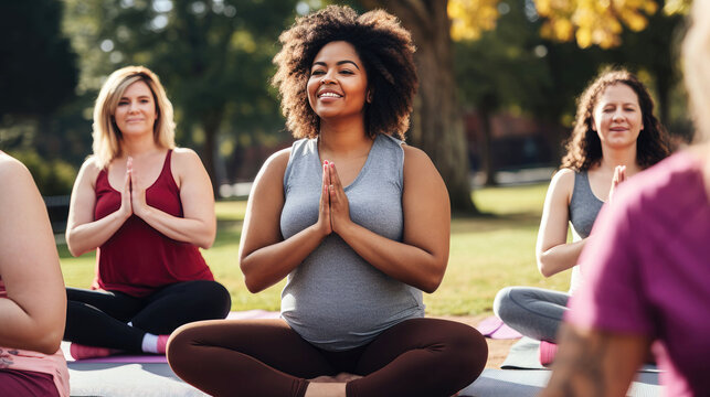 Diverse group of women practicing outdoor yoga session in park
