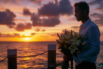 man on a pier at sunset, holding a bunch of lilies