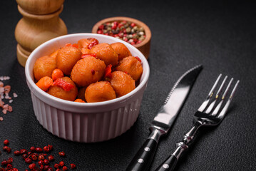 Delicious fried potato balls with vegetables, salt, spices and herbs