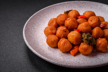 Delicious fried potato balls with vegetables, salt, spices and herbs