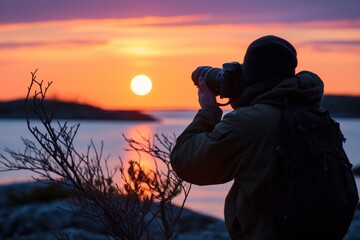 photographer with camera focused on midnight sun
