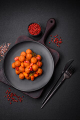 Delicious fried potato balls with vegetables, salt, spices and herbs