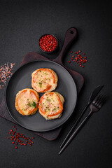 Delicious baked fish fillet with cheese, tomatoes, salt, spices and herbs