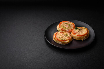 Delicious baked fish fillet with cheese, tomatoes, salt, spices and herbs