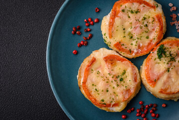 Delicious baked fish fillet with cheese, tomatoes, salt, spices and herbs