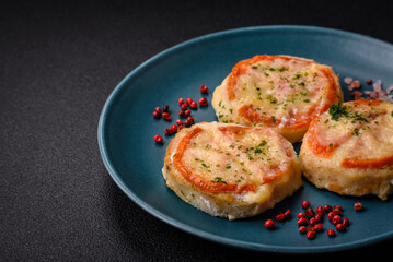 Delicious baked fish fillet with cheese, tomatoes, salt, spices and herbs