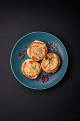 Delicious baked fish fillet with cheese, tomatoes, salt, spices and herbs